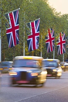 Taxi Prints: Black cabs along The Mall with Union Jack flags, London, England, United Kingdom, Europe