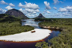 Colombia Prints: Black river and white sand beach in front of granite hills