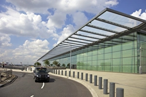 Cabs Prints: Black taxi cab drives away from Terminal 4, Heathrow Airport, London, England