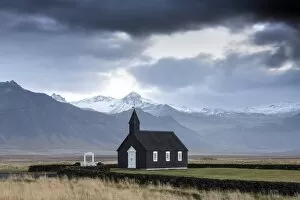 Snaefellsnes Peninsula Gallery: Black wooden church against mountains, Budir, Snaefellsnes Peninsula, Iceland, Polar