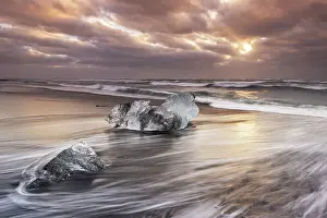Black Sand Prints: A block of ice deposited on Diamond Beach near the famous Jokusarloon Glacier Lagoon