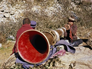 Ganden Prints: Blowing giant horn at Ganden Monastery, Tibet, China, Asia