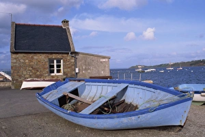 Rowing Boat Prints: Blue boat on shore with the harbour of Le Fret behind, Brittany, France, Europe