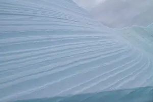 Melting Prints: Detail of blue color on iceberg surface near Antarctic Peninsula during austral summer months