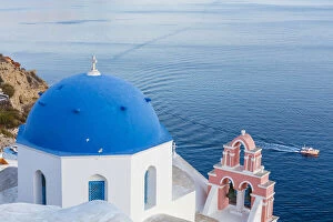 Santorini Gallery: Blue domed white church overlooking boat in Aegean Sea, Santorini, Cyclades, Greek Islands, Greece