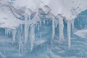 Glacial Prints: Detail of blue ice and icicles in Antarctica during Austral summer months around the Antarctic Peninsula