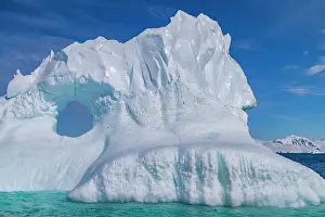 Glacier Prints: Detail of blue around an iceberg in Antarctica during summer months shows structure and formations