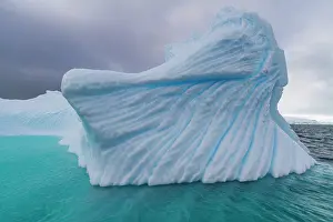 Chilly Prints: Detail of a blue iceberg in the waters surrounding Antarctica during the summer months