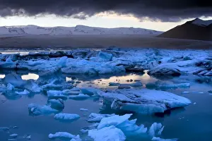 Blue Colour Prints: Blue icebergs floating on the Jokulsarlon glacial lagoon at sunset, South Iceland