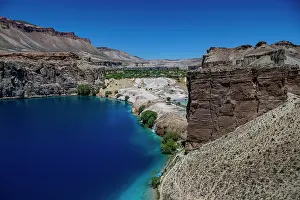 Fresh Prints: Blue lake reflects clear sky in Band-e-Amir National Park in Afghanistan near the mountains and cliffs during the day