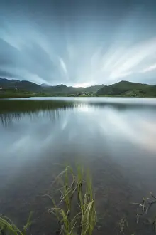 Vestvagoy Prints: Blue lights at night illuminate the calm sea surrounded by rocky peaks, Holdalsvatnet
