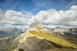 Mountain Ridge Prints: Blue sky and clouds on the rocky peaks of the Odle mountain range seen from Seceda
