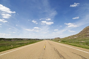 Blue sky over a highway through the Badlands of Alberta, near Drumheller, Alberta