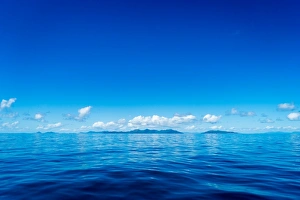 Seascape Prints: Blue sky and ocean with islands in the background, Queensland, Australia, Pacific