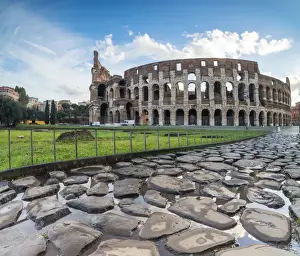 Blue sky at sunrise frames the ancient Colosseum (Flavian Amphitheatre), UNESCO World Heritage Site