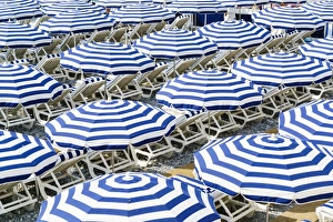 Blue and white beach parasols, Nice, Alpes Maritimes, Cote d Azur, Provence, France