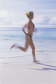 Bare Foot Prints: Blurred motion image of a woman jogging on the beach