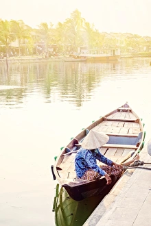 Floral Pattern Prints: A boat driver in a conical hat in Hoi An, Vietnam, Indochina, Southeast Asia, Asia