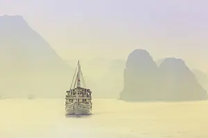 Typically Vietnamese Prints: Boat on Halong Bay at sunset, UNESCO World Heritage Site