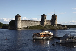 Images Dated 21st June 2009: Boat moored in front of Olavinlinna Medieval Castle (St. Olafs Castle)