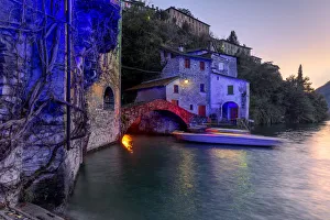 Light Beam Prints: Boat in motion under the illuminated Nesso bridge, Lake Como, Lombardy, Italian Lakes