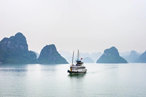 Karst Prints: A boat passes through foggy karst landscape in Ha Long Bay, Quang Ninh Province, Vietnam