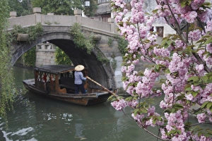 Weekend Activities Prints: Boat passing under bridge along canal, Suzhou, Jiangsu, China, Asia