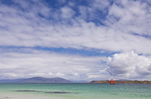 Boat with red sails off Traigh Bhan beach