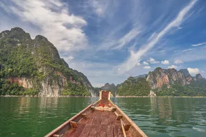 Mountainous Prints: Boat riding through mountain lake view with tropical forest at Sam Klur mountain Khaosok National Park