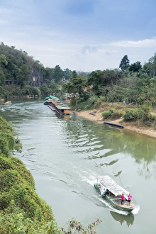 Kanchanaburi Prints: A boat on the River Kwai with the POW-built Wampoo Viaduct behind