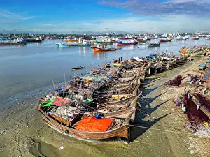 Nets Prints: Boats anchor along the Karnaphuli River with fish market activity in Chittagong