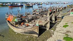 Stalls Prints: Boats anchor on Karnaphuli River near fish market in Chittagong with bustling trade activity