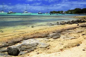 Northern Prints: Boats anchored near sandy shore with rocks and water in Cap Malheureux