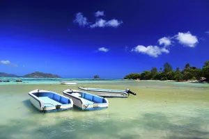 Paradise Prints: Boats anchored in shallow water at Anse Source dArgent beach in La Digue Seychelles during a sunny day