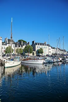 Enjoyment Prints: Boats are docked in a harbor with clear blue skies above in a coastal town in France