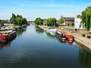 Canals Prints: Boats docked along the River Great Ouse in Ely Cambridgeshire during a clear day in late spring