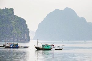 Boats in Ha Long Bay on a foggy morning, UNESCO World Heritage Site, Quang Ninh Province