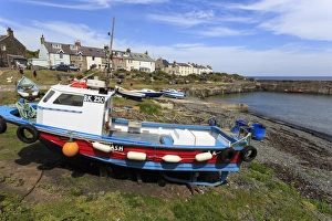 Northumberland Prints: Boats on harbour foreshore at low tide on a sunny summer day, Craster, Northumberland