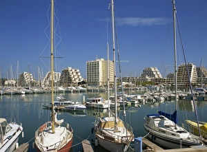 La Grande Motte Prints: Boats in the harbour and modern buildings in the background, at La Grande Motte
