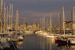 Boats in the harbour and the railway station behind in Ostend, Belgium, Europe