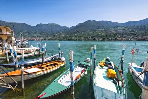 Wooden Post Prints: Boats moored at Monte Isola, the largest lake island in Europe, Province of Brescia