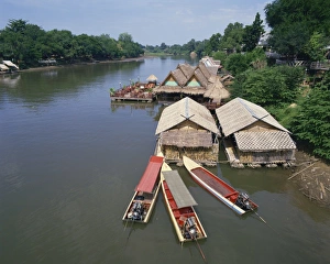 River Kwai Prints: Boats moored near a restaurant on the Kwai River in Thailand