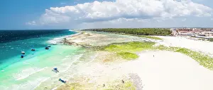 Zanzibar Prints: Boats moored in the turquoise waters of the Indian Ocean overlooking an empty beach
