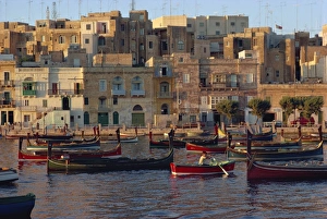Boats moored in Valletta harbour at dusk