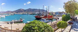 Yacht Prints: Boats at Port of Hersonissos with clear skies and mountains in the distance in Limenas Chersonisou Crete Greece