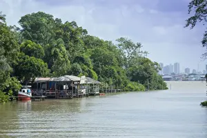 Belem Prints: Boats and stilt house on an igarape (flooded creek) in the Brazilian Amazon with Belem city behind