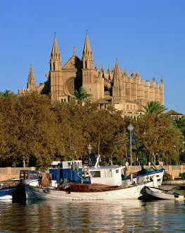 Cathedrals Prints: Boats on the waterfront below the cathedral of Palma, on Majorca, Balearic Islands