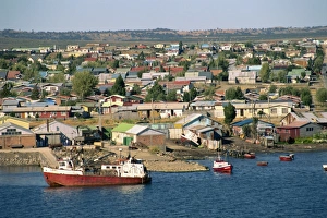 Magallanes Prints: Boats on the waterfront and the town of Puerto Natales, in Magallanes, Chile