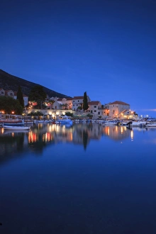 Bol Harbour lit up at dusk, Bol, Brac Island, Dalmatian Coast, Croatia, Europe