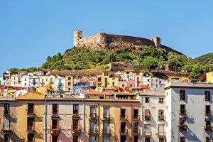 Town Center Prints: Bosa city colorful buildings with castle on top of the hill and Vecchio bridge crossing Temo river
